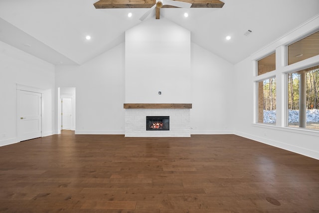 unfurnished living room with beamed ceiling, a fireplace, dark hardwood / wood-style floors, and high vaulted ceiling