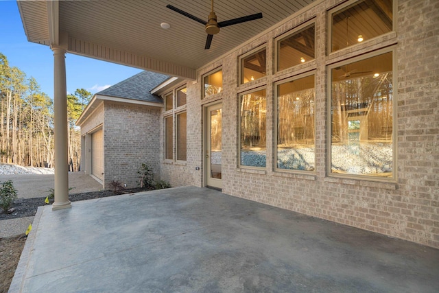 view of patio / terrace with ceiling fan and a garage