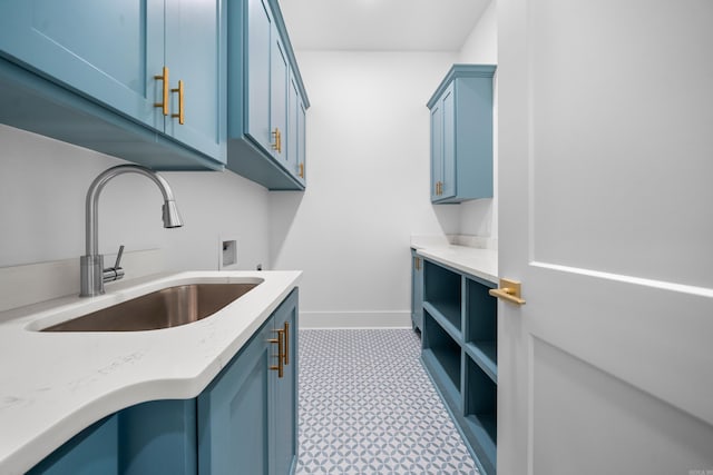 clothes washing area featuring cabinets, hookup for a washing machine, and sink