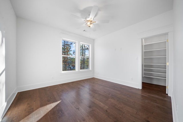 unfurnished room with dark hardwood / wood-style floors and ceiling fan