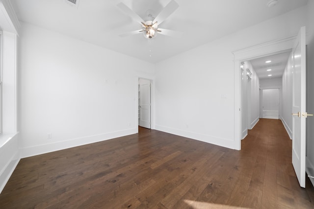 empty room featuring ceiling fan and dark hardwood / wood-style flooring