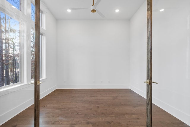 empty room with dark wood-type flooring and ceiling fan