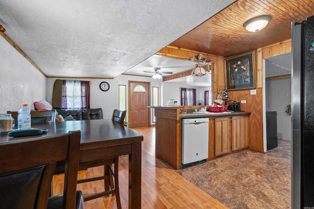 kitchen with stainless steel fridge, kitchen peninsula, wooden ceiling, ceiling fan, and dishwasher