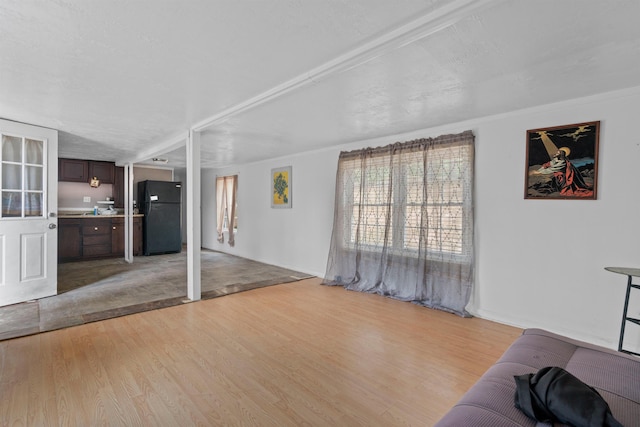 living room with ornamental molding and light hardwood / wood-style floors