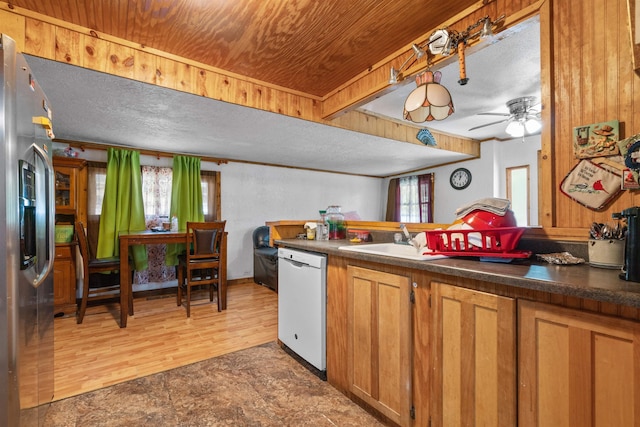 kitchen featuring stainless steel refrigerator with ice dispenser, ceiling fan, dark hardwood / wood-style flooring, white dishwasher, and sink