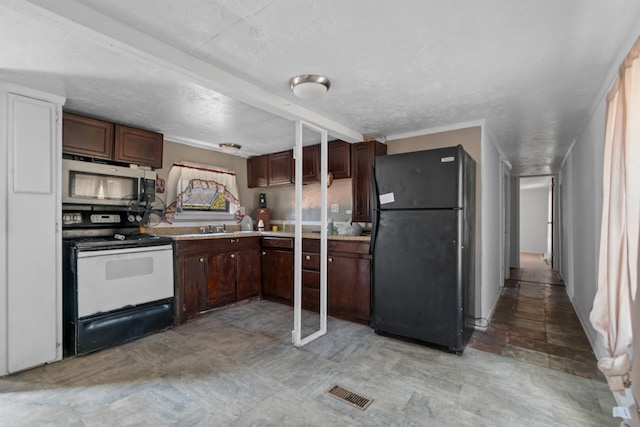 kitchen featuring electric stove, a textured ceiling, black fridge, and sink