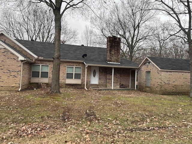 rear view of house with a yard