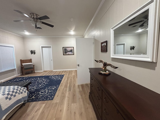 bedroom with ceiling fan, light wood-type flooring, and crown molding