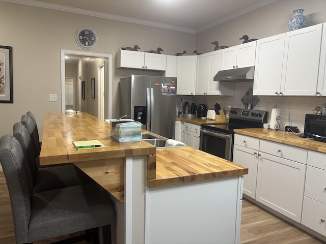 kitchen featuring white cabinets, appliances with stainless steel finishes, and butcher block counters