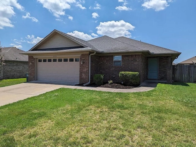 single story home featuring a garage and a front lawn