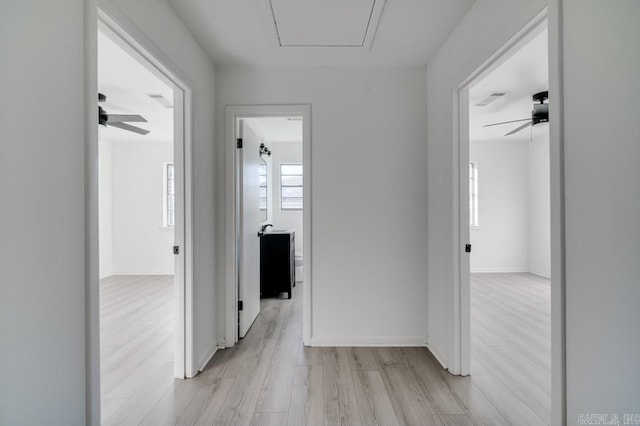 corridor with light wood-type flooring