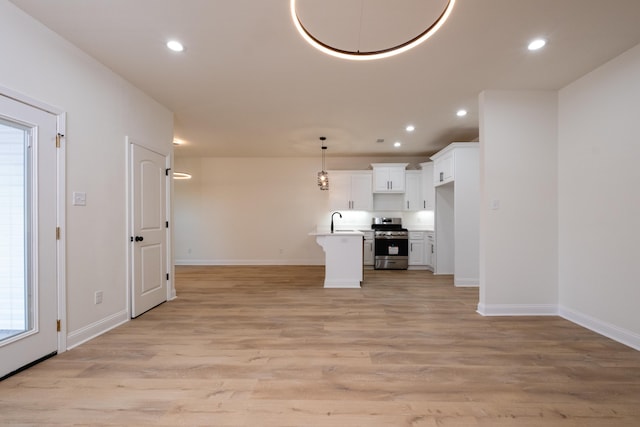 unfurnished living room featuring light hardwood / wood-style floors and sink