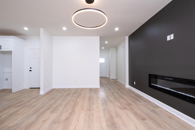 unfurnished living room with light hardwood / wood-style flooring