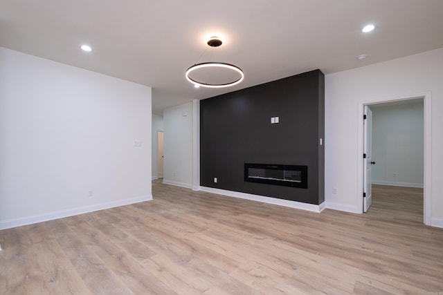 unfurnished living room with light hardwood / wood-style flooring and a fireplace