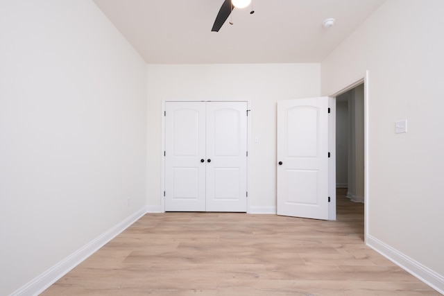 unfurnished bedroom featuring ceiling fan, a closet, and light hardwood / wood-style flooring