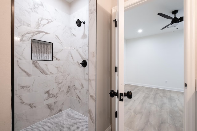 bathroom with ceiling fan, hardwood / wood-style floors, and tiled shower