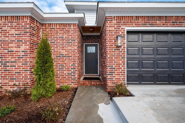 doorway to property with a garage