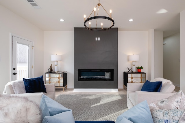 living room with a chandelier and a fireplace