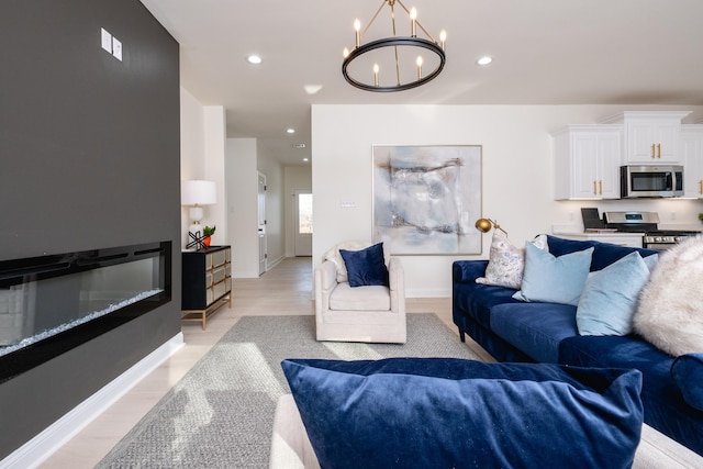 living room with light wood-type flooring and an inviting chandelier