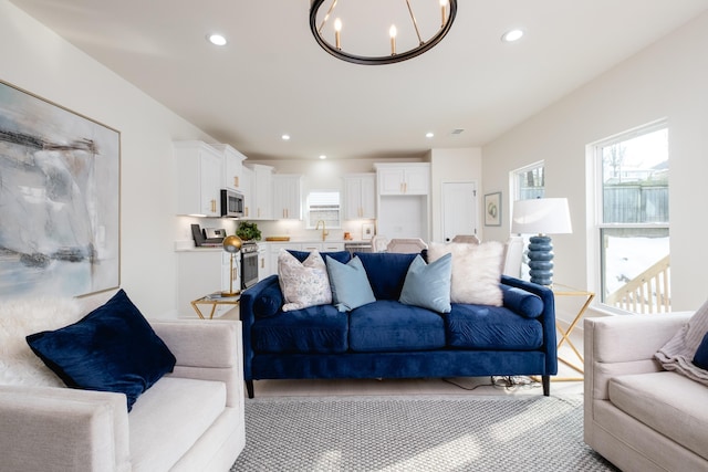 living room featuring sink and a notable chandelier