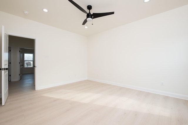 unfurnished room with ceiling fan and light hardwood / wood-style floors