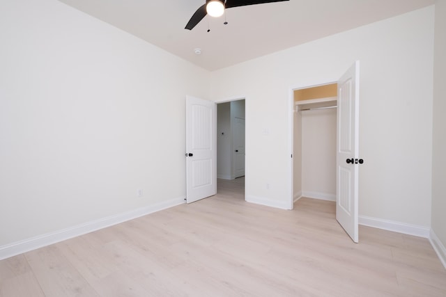 unfurnished bedroom featuring ceiling fan, a closet, and light hardwood / wood-style flooring