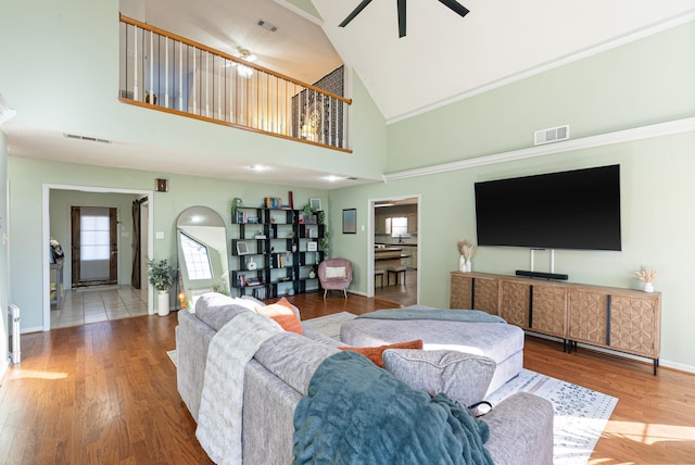 living room featuring high vaulted ceiling, ceiling fan, and hardwood / wood-style flooring