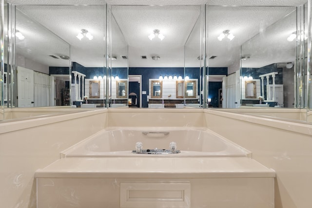 bathroom featuring a tub to relax in and a textured ceiling