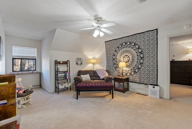 interior space featuring a textured ceiling, ceiling fan, and lofted ceiling