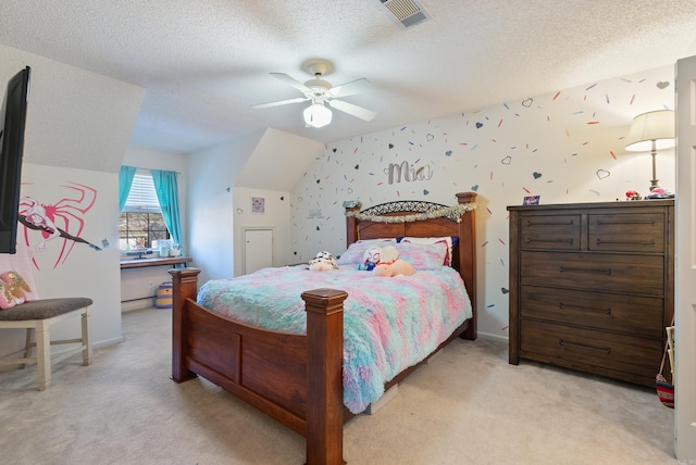 carpeted bedroom featuring ceiling fan and a textured ceiling