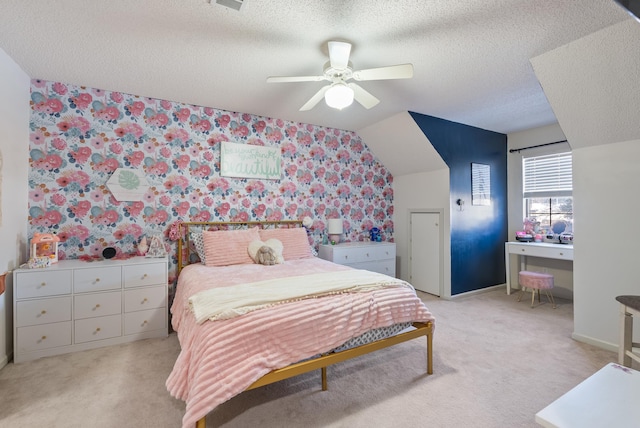 carpeted bedroom featuring ceiling fan, a textured ceiling, and lofted ceiling