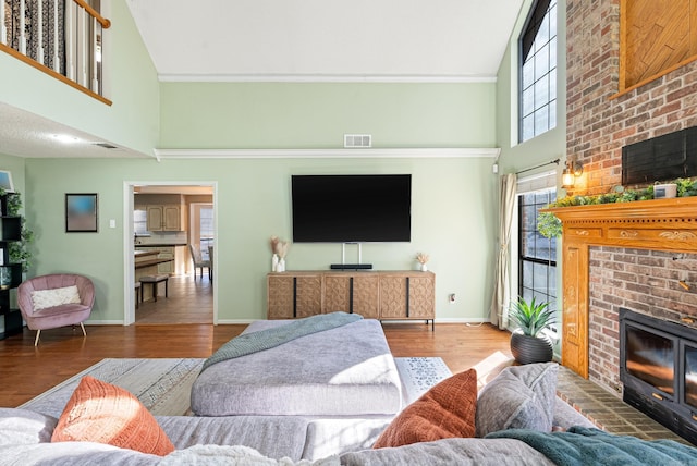 living room with a high ceiling and hardwood / wood-style flooring