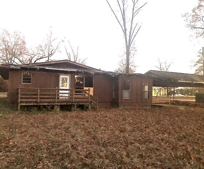 back of house featuring a deck