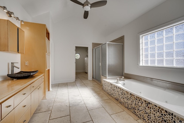 bathroom featuring ceiling fan, vanity, separate shower and tub, and lofted ceiling