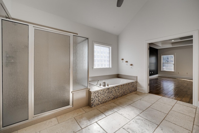 bathroom featuring ceiling fan, lofted ceiling, and separate shower and tub