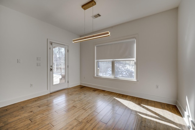 unfurnished room with light wood-type flooring