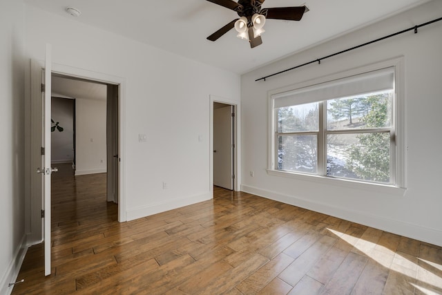 unfurnished bedroom with ceiling fan and hardwood / wood-style floors