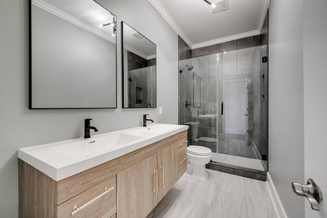 bathroom featuring toilet, crown molding, a shower with door, and vanity