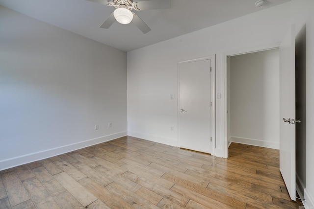 spare room with light wood-type flooring and ceiling fan