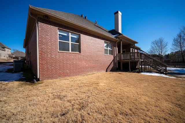 back of house with a wooden deck, a yard, and central air condition unit