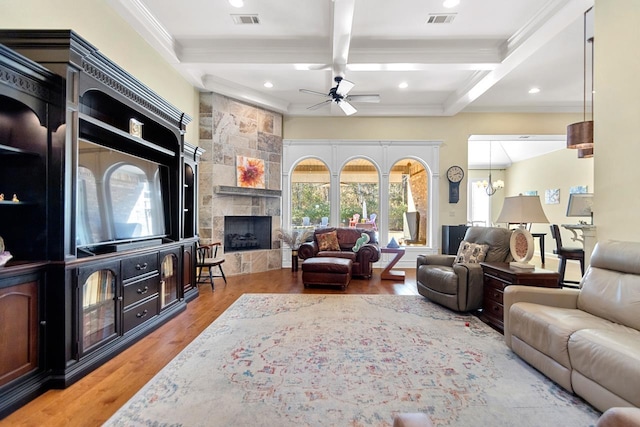 living room featuring ceiling fan, a fireplace, beam ceiling, coffered ceiling, and hardwood / wood-style flooring