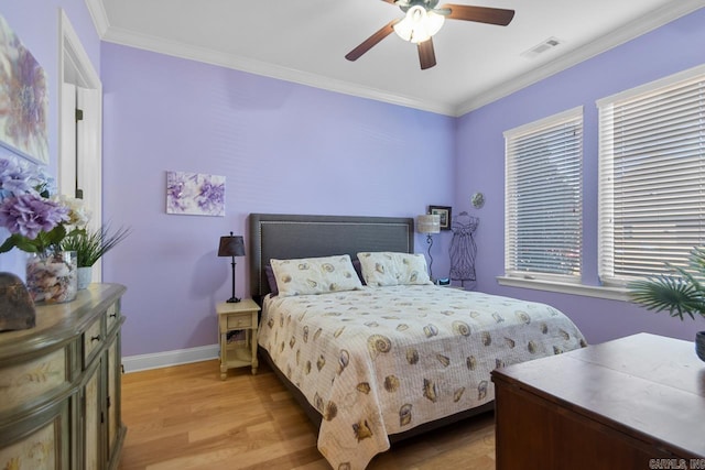 bedroom with ceiling fan, crown molding, and light hardwood / wood-style flooring