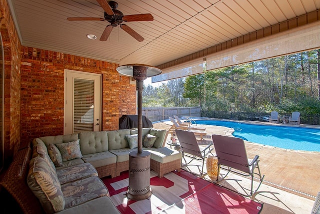 view of patio with ceiling fan, a fenced in pool, and an outdoor living space