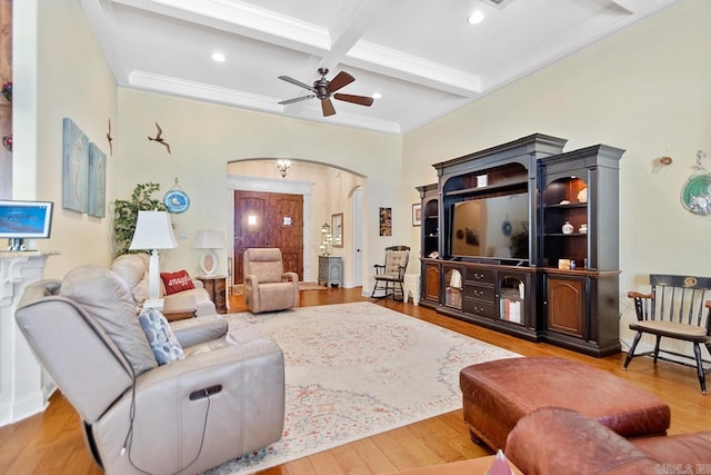 living room with hardwood / wood-style floors, beamed ceiling, ceiling fan, crown molding, and coffered ceiling