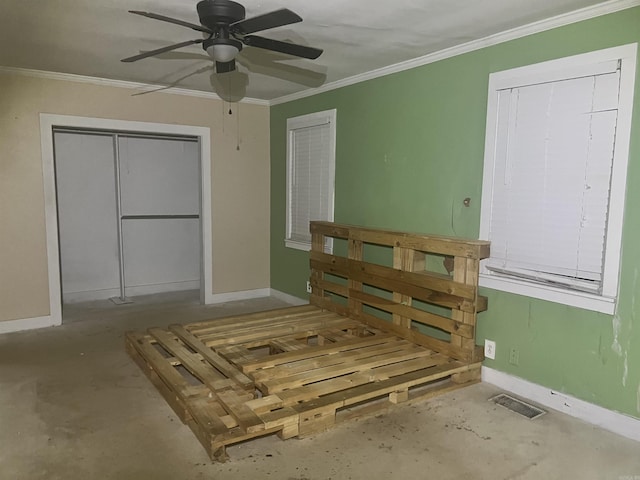 bedroom with ceiling fan, crown molding, and multiple closets