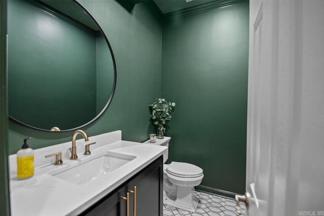 bathroom with vanity, tile patterned floors, ornamental molding, and toilet