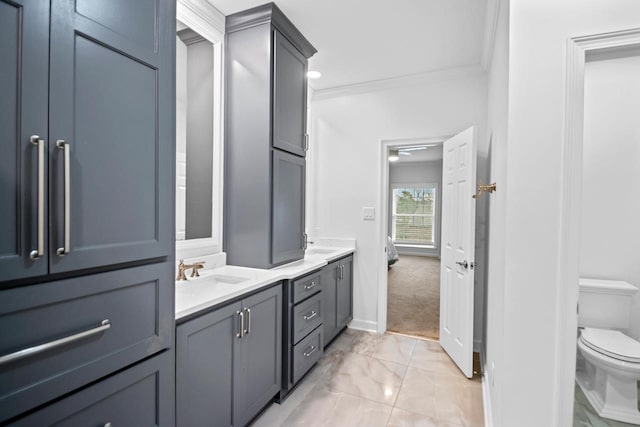 bathroom featuring vanity, crown molding, and toilet