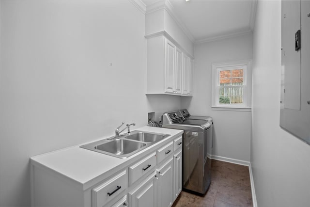 laundry room featuring crown molding, cabinets, sink, and washing machine and clothes dryer