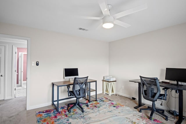 office space with light carpet and ceiling fan