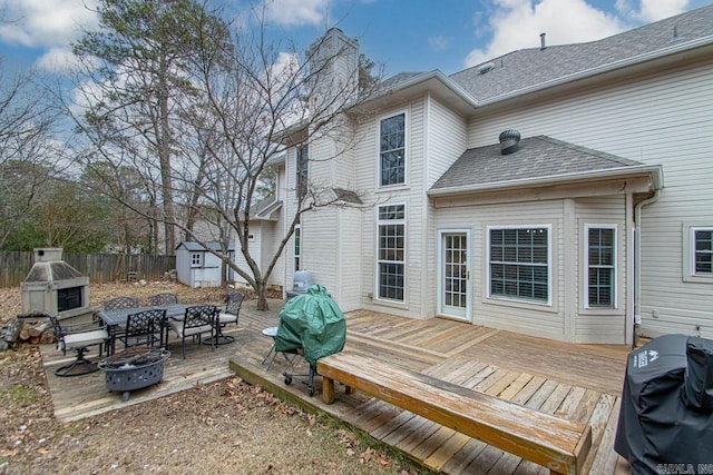 exterior space with a grill, a shed, and an outdoor fire pit